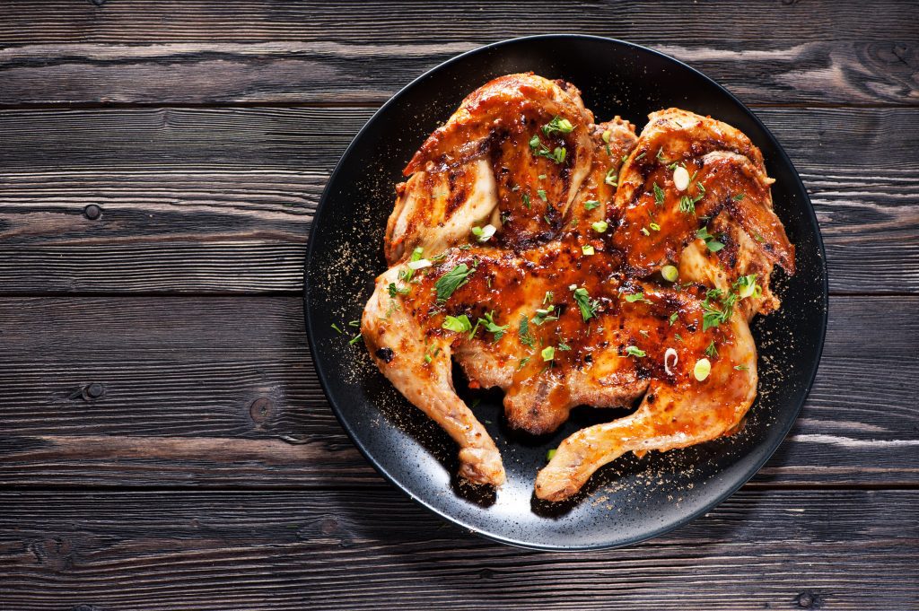 Grilled fried roast Chicken Tabaka on a plate