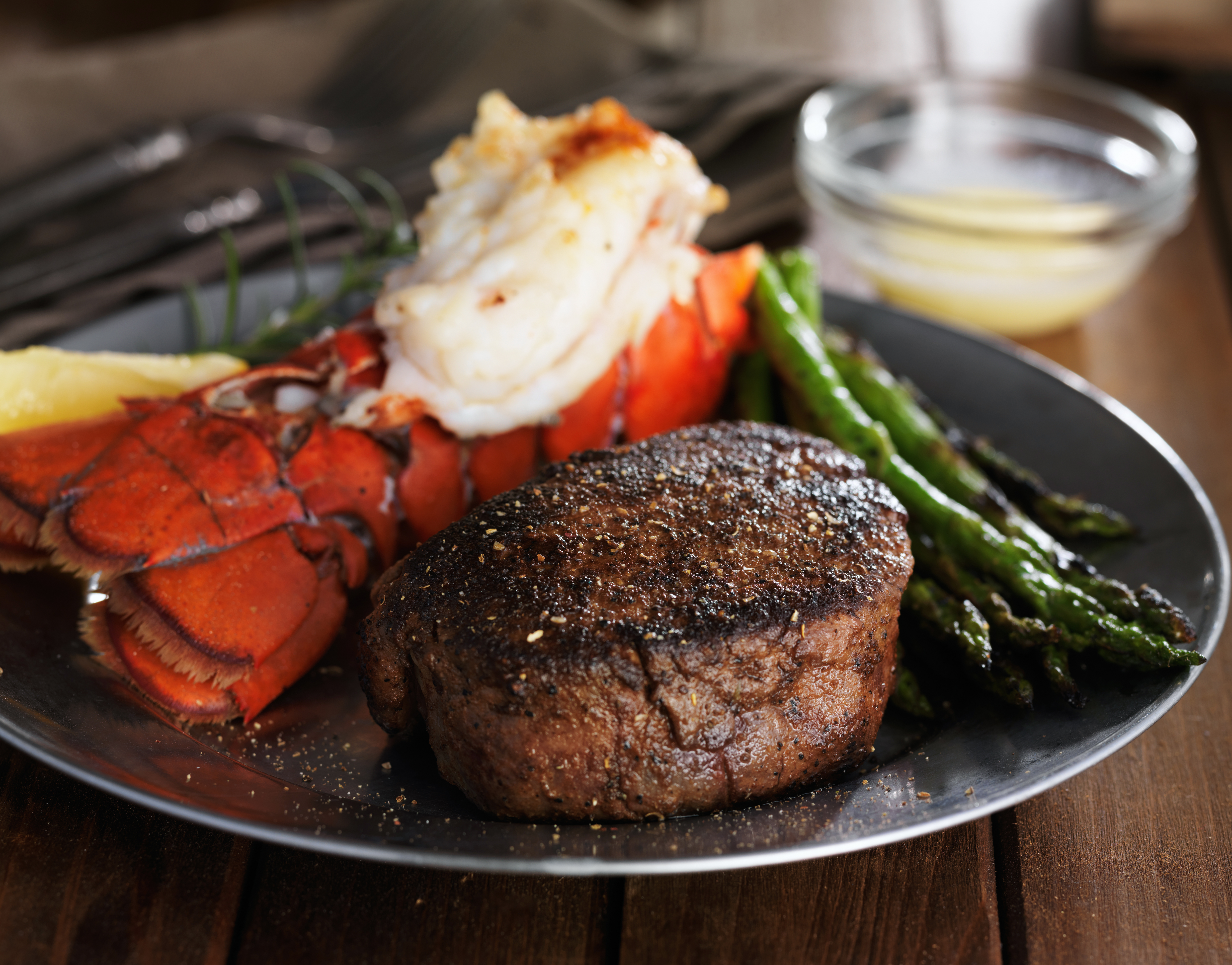 surf and turf meal with filet mignon, lobster tail and asparagus